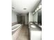 Updated bathroom featuring a soaking tub, glass shower, and dual granite countertops at 395 Central Park Ne Pl # 610, Atlanta, GA 30312