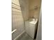 Simple laundry area with a white washing machine and wire shelving at 395 Central Park Ne Pl # 610, Atlanta, GA 30312