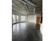Open-concept living area with exposed ductwork, large windows and polished concrete floors at 395 Central Park Ne Pl # 610, Atlanta, GA 30312
