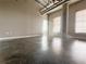 Spacious living room with concrete floors, high ceilings, and large windows for natural light at 395 Central Park Ne Pl # 610, Atlanta, GA 30312