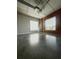 Bright living area showcasing exposed brick, concrete floors, and large windows at 395 Central Park Ne Pl # 610, Atlanta, GA 30312