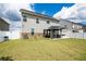 Spacious backyard with a large gazebo and patio seating area against a backdrop of a well-manicured lawn and white fence at 13568 Scenic Pkwy, Covington, GA 30014