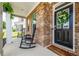 Cozy front porch with rocking chairs, brick accents, and welcoming curb appeal at 13568 Scenic Pkwy, Covington, GA 30014