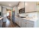 Modern kitchen with stainless steel appliances, quartz countertops, and gray cabinetry at 13568 Scenic Pkwy, Covington, GA 30014