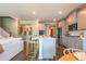 Bright eat-in kitchen featuring a large island with counter seating, stainless appliances, and hardwood floors at 13568 Scenic Pkwy, Covington, GA 30014