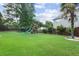 Large grassy backyard featuring a playground, gazebo and mature trees at 3190 Red Rose Dr, Powder Springs, GA 30127