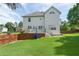 Back exterior view showing a spacious backyard with a manicured lawn and privacy fence at 3190 Red Rose Dr, Powder Springs, GA 30127