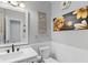 Well-lit bathroom with a white vanity, framed mirror, and decorative wall art at 3190 Red Rose Dr, Powder Springs, GA 30127