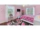 Pink themed bedroom with TV, a window view, and cheerful decor at 3190 Red Rose Dr, Powder Springs, GA 30127