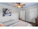 Bedroom featuring a ceiling fan, hardwood floors and access to other rooms at 3190 Red Rose Dr, Powder Springs, GA 30127