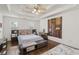 Spacious bedroom featuring a tray ceiling, large windows, and hardwood floors at 3190 Red Rose Dr, Powder Springs, GA 30127