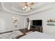 Bright bedroom with a decorative tray ceiling and an en-suite bathroom at 3190 Red Rose Dr, Powder Springs, GA 30127