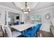 Bright dining room with elegant lighting fixture and views into the living room at 3190 Red Rose Dr, Powder Springs, GA 30127