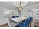 Bright dining room boasts a marble top table, elegant chandelier, and large windows at 3190 Red Rose Dr, Powder Springs, GA 30127