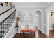 Elegant foyer boasts hardwood floors, stylish mirror, and an staircase with iron railings at 3190 Red Rose Dr, Powder Springs, GA 30127