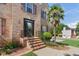 Home exterior with brick facade, landscaped garden, and a welcoming front door with decorative details at 3190 Red Rose Dr, Powder Springs, GA 30127