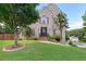 Charming brick home features a well-manicured lawn, mature trees, and inviting curb appeal at 3190 Red Rose Dr, Powder Springs, GA 30127
