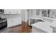 Modern kitchen with stainless steel appliances, white cabinets, and hardwood floors at 3190 Red Rose Dr, Powder Springs, GA 30127