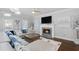 Cozy living room featuring a fireplace, large sectional sofa, and modern accents at 3190 Red Rose Dr, Powder Springs, GA 30127