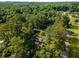 An aerial shot captures the home nestled among lush greenery and mature trees at 4149 Indian Lake Cir, Stone Mountain, GA 30083