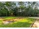 A spacious grassy backyard features mature trees and a concrete patio area at 4149 Indian Lake Cir, Stone Mountain, GA 30083