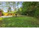 A sprawling, grassy backyard provides ample space for outdoor activities and relaxation at 4149 Indian Lake Cir, Stone Mountain, GA 30083