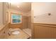 Bathroom features a bathtub with tiled surround and a granite vanity top at 4149 Indian Lake Cir, Stone Mountain, GA 30083