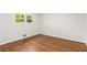 Bright bedroom with hardwood floors and a view of lush greenery outside at 4149 Indian Lake Cir, Stone Mountain, GA 30083