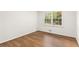 Empty bedroom with hardwood floors and natural light from a window at 4149 Indian Lake Cir, Stone Mountain, GA 30083