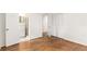 Spacious bedroom with hardwood floors, closet, and adjacent bathroom at 4149 Indian Lake Cir, Stone Mountain, GA 30083