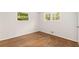 Bright bedroom with two windows and gleaming hardwood floors at 4149 Indian Lake Cir, Stone Mountain, GA 30083