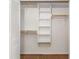Spacious closet with custom shelving and wooden rods for ample storage at 4149 Indian Lake Cir, Stone Mountain, GA 30083