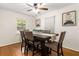 Dining area showcasing a dark wood table with gray chairs, a decorative centerpiece, and hardwood floors at 4149 Indian Lake Cir, Stone Mountain, GA 30083