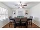 Dining area featuring a modern table with gray upholstered chairs, hardwood floors, and natural light at 4149 Indian Lake Cir, Stone Mountain, GA 30083
