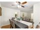 Formal dining room features a ceiling fan, wood floors and a view of other living areas at 4149 Indian Lake Cir, Stone Mountain, GA 30083