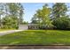 Well-manicured front yard with a charming brick home and driveway at 4149 Indian Lake Cir, Stone Mountain, GA 30083