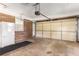 Garage with exposed brick, a fridge, and automatic door at 4149 Indian Lake Cir, Stone Mountain, GA 30083