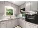 Classic kitchen with gray cabinets, granite countertops, tile backsplash, and updated appliances at 4149 Indian Lake Cir, Stone Mountain, GA 30083