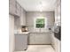 Galley kitchen with white cabinets, granite countertops, and stainless steel appliances at 4149 Indian Lake Cir, Stone Mountain, GA 30083
