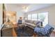 Open-concept living room with hardwood floors, neutral paint, and backyard view at 4149 Indian Lake Cir, Stone Mountain, GA 30083
