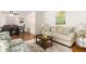 Inviting living room featuring a plush sofa, patterned armchairs, and a stylish coffee table on a soft rug at 4149 Indian Lake Cir, Stone Mountain, GA 30083
