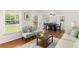 Cozy living room and dining area featuring hardwood floors, seating, and natural light from the windows at 4149 Indian Lake Cir, Stone Mountain, GA 30083