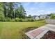 Large grassy backyard featuring a patio area, providing ample space for outdoor activities at 5900 Union Woods Way, Union City, GA 30291