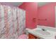 Charming bathroom featuring colorful walls, a vanity, and shower with a patterned curtain at 5900 Union Woods Way, Union City, GA 30291