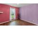 Bright bedroom with wood floors, a window, and colorful walls at 5900 Union Woods Way, Union City, GA 30291