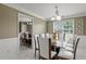 Elegant dining room with a glass-top table, white chairs, and modern chandelier at 5900 Union Woods Way, Union City, GA 30291