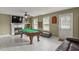 Spacious game room featuring a pool table, fireplace, and large-screen TV at 5900 Union Woods Way, Union City, GA 30291