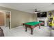 Game room with a pool table, flat-screen TV, and fireplace at 5900 Union Woods Way, Union City, GA 30291