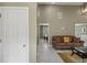 Inviting living room features neutral walls, tiled floor, and an elegant leather sofa at 5900 Union Woods Way, Union City, GA 30291