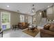 Bright living room features large windows and tile flooring at 5900 Union Woods Way, Union City, GA 30291